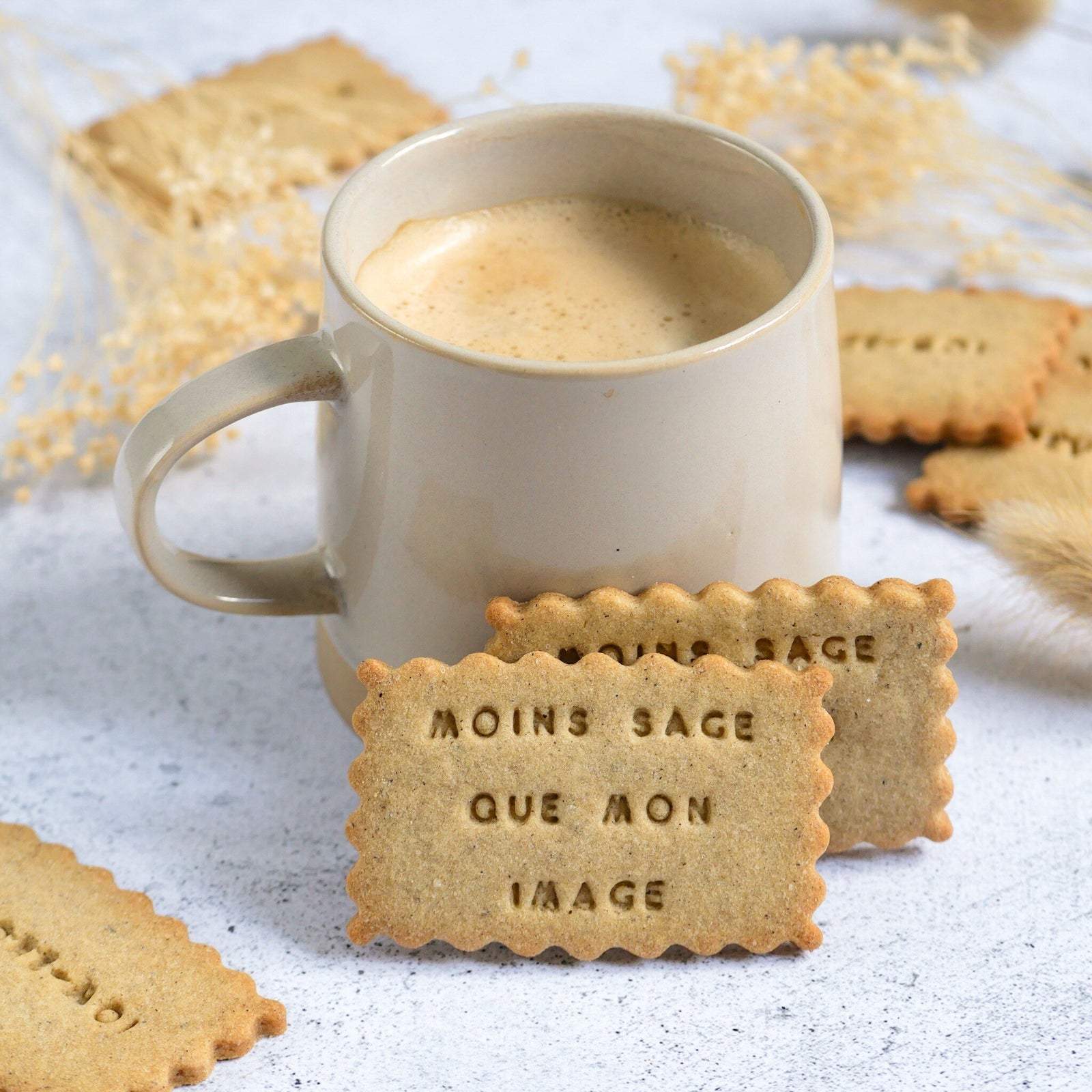 Biscuits personnalisés à message posés contre une tasse de café